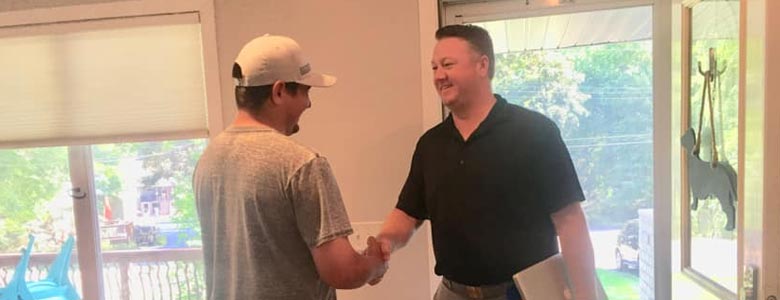 Bill shaking hands with a client